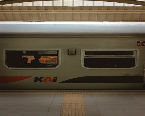 indonesian man commuting on modern train looking tired